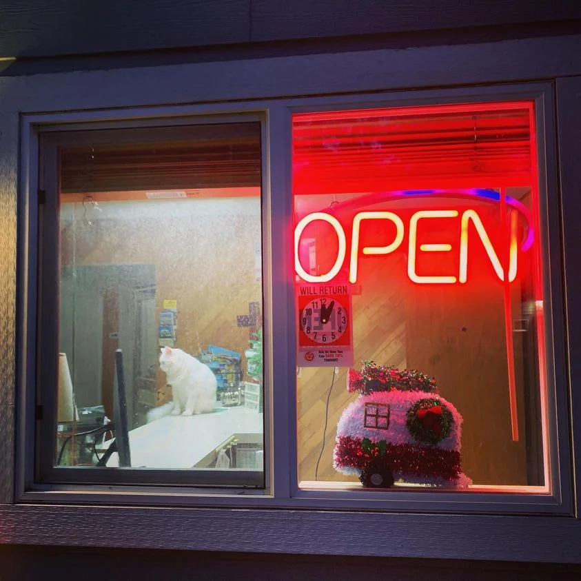 office window with neon open sign